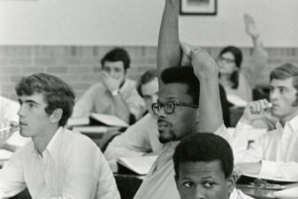 Student raising their hand in class.